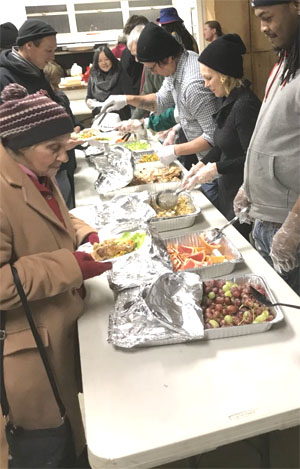 Serving food at a long table